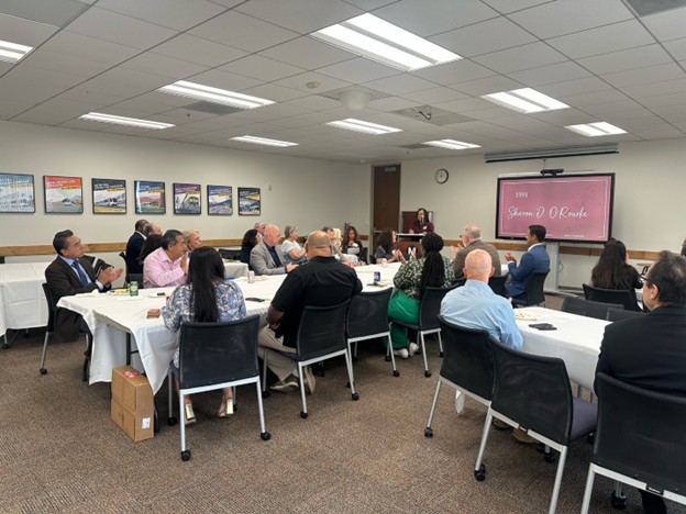 Image of president neidy pinuelas speaking to attendees
