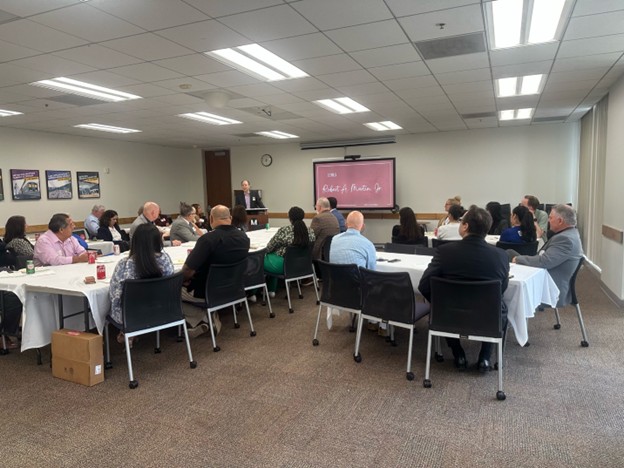 image of past president bill larsen speaking to attendees